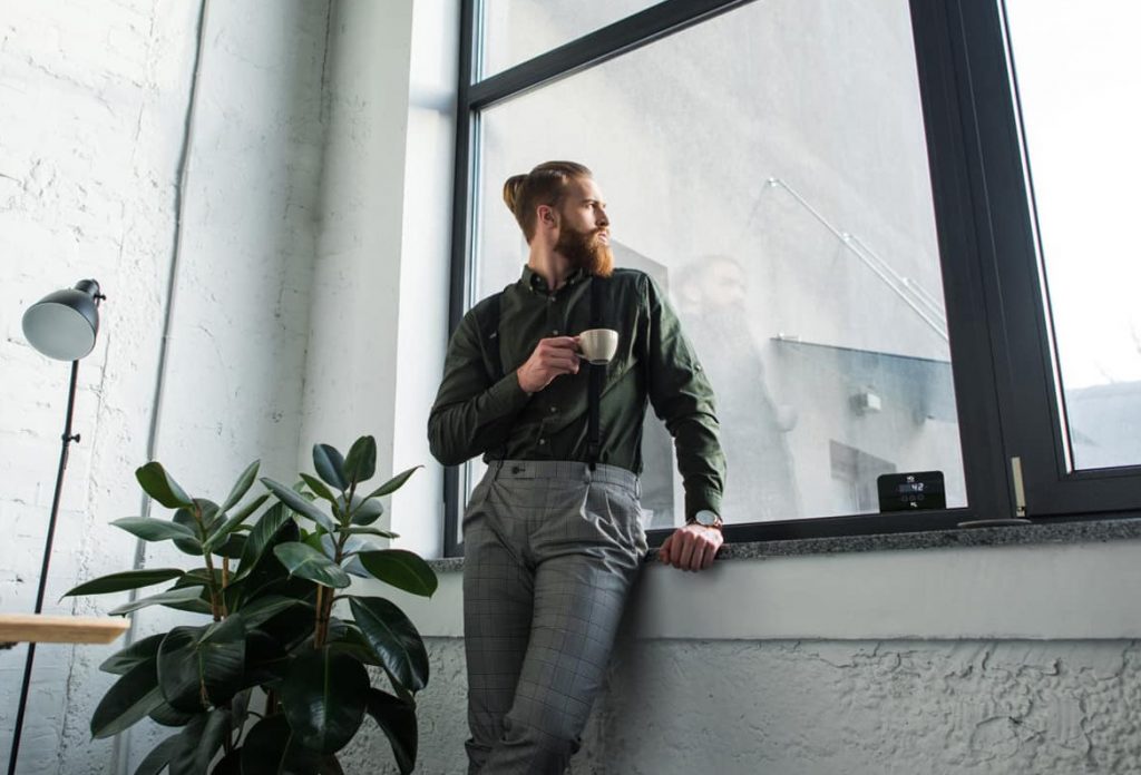 A man looking out of a smart heated window of the HQ glass.