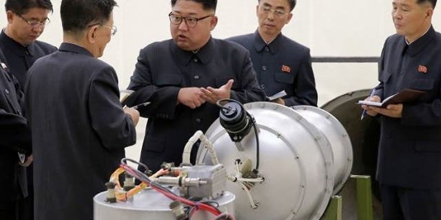 Kim Jong Un pictured in September with what appeared to be a nuclear device after the hermit kingdom's sixth nuclear test.